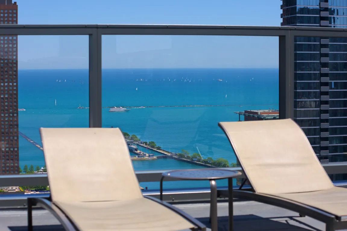 living room with wood floors and downtown view at Aston Chicago Apartments