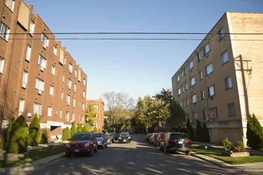 cars parked on side streets between brick mid-rise apartment buildings in Bowmanville Chicago