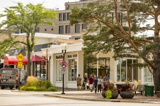 family walking in downtown Highland Park past retail stores