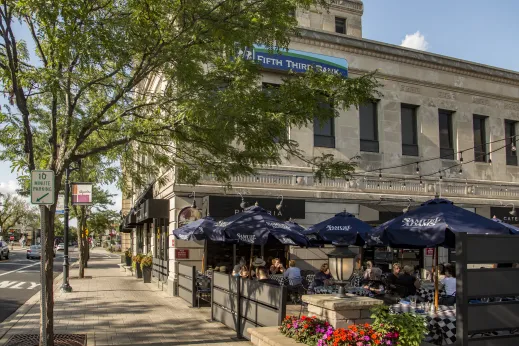 patio with people eating and drinking in front of bank in downtown Elmhurst Illinois