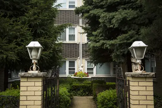 outdoor brick fountain with flowers surrounding it in courtyard of apartment building in the O’Hare neighborhood of Chicago