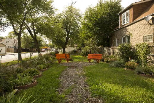 Green space and garden on corner lot in neighborhood near houses and apartments in Austin Chicago