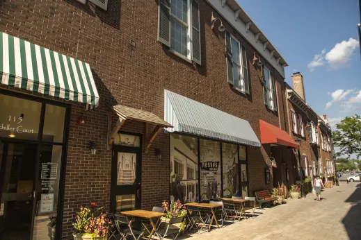 storefronts with green and white striped awnings in downtown Elmhurst Illinois