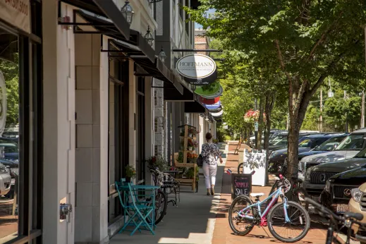 Hoffman woman walking bikes cars store fronts Winnetka