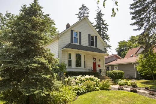 large white single family home with landscaped front yard in Des Plaines, IL