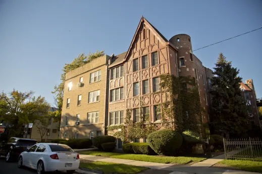 old beautiful brick apartment building in Bowmanville Chicago covered in ivy vines