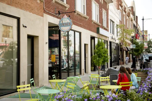 Josis Frozen yogurt sign and outdoor seating with customers in Portage Park