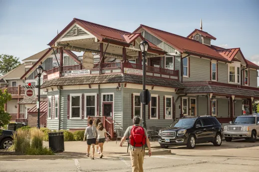 Lamplighter Inn with red roof from across the street with people crossing street in Palatine, Illinois