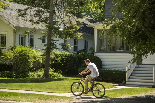 Man biking neighborhood lawn home Winnetka