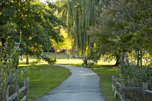 man sitting in park on bench in autumn in Bowmanville Chicago