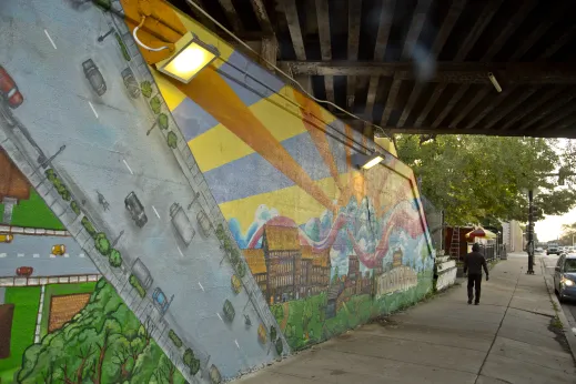 Man walking near mural in Kilbourn Park Chicago