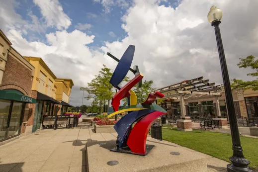 large colorful exterior sculpture next to grass in courtyard of building in Schaumburg, Illinois
