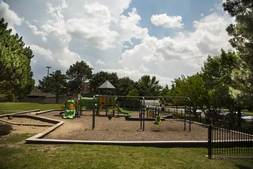 kids playground surround by grass and trees in the O’Hare neighborhood of Chicago
