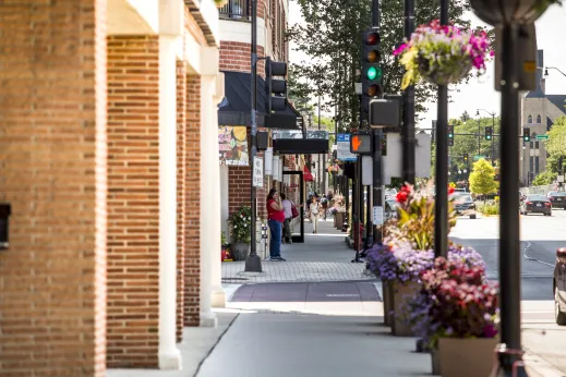 people walking on sidewalk by retail in downtown Skokie, IL