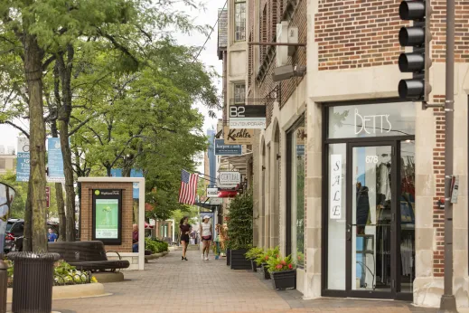 people walking in downtown Highland Park past stores