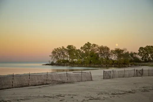 Sandy beach and rocky outcrop into Lake Michigan in South Shore Chicago