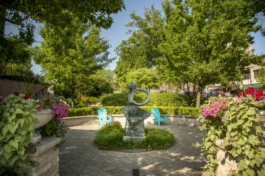 Statue blue chairs flowers grass trees Park Ridge, IL