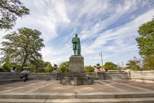 Statue Kids backpack taken from below with plaza in front and trees surrounding in McKinley Park Chicago