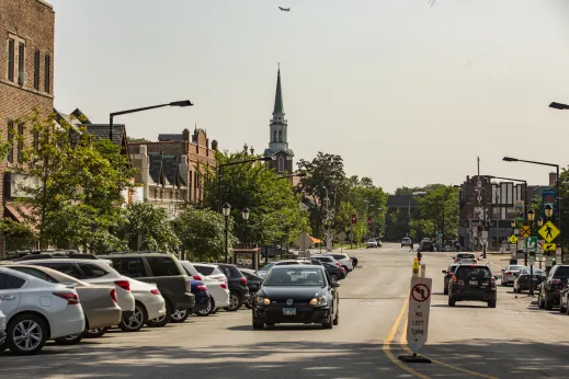 Street cars steeple uptown buildings traffic Park Ridge Illinois