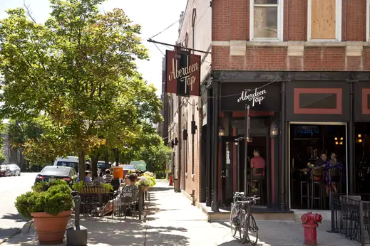 The Aberdeen Tap bar and lounge with customers sitting on outdoor patio and front entrance in the West Loop