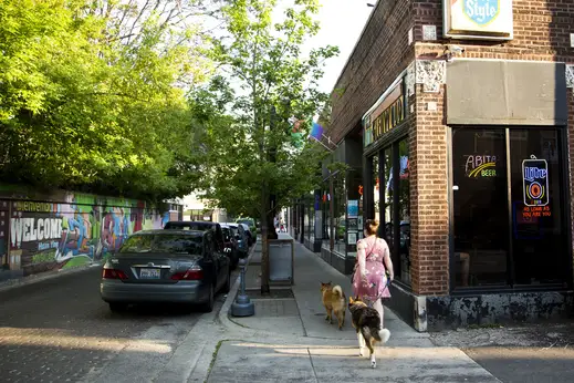 The Glenwood bar and woman walking dogs in Rogers Park Chicago