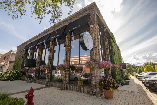 The Musci Room storefront with large glass windows surrounded by shrubs in Palatine, Illinois