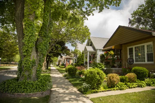 single family home and grass lawn with trees in Dunning Chicago