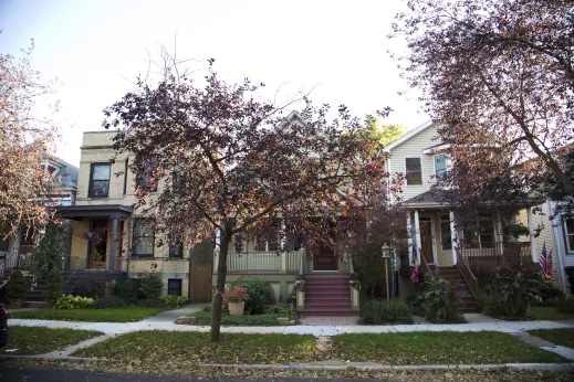 red leaves of autumn on trees in front of apartments for rent in Bowmanville Chicago