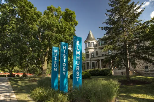 trees on sidewalk in front of historic Elmhurst Museum in Elmhurst Illinois
