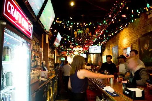 Bartender serving patrons at bar in Lincoln Park Chicago