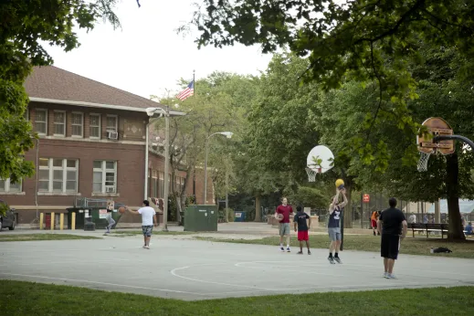 Basketball players at outdoor court in Hamlin Park Chicago