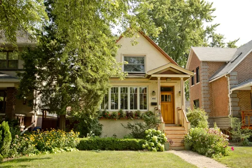 Beige single family home and front garden in Portage Park Chicago