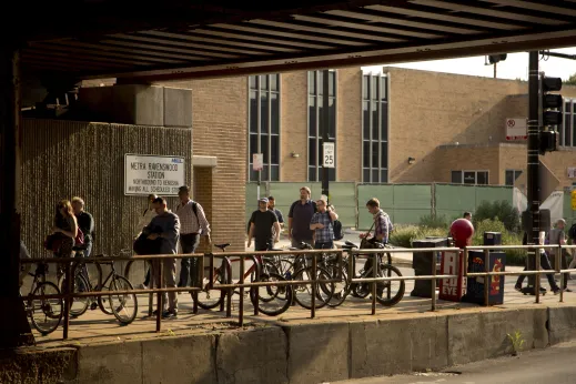Bicycle parking and commuters walking to Metra Ravenswood station under viaduct in Ravenswood