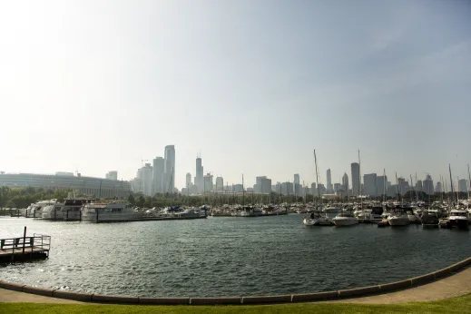 Boats moored in Burnham Harbor and Soldier Field and Chicago skyline in the background in the South Loop Chicago