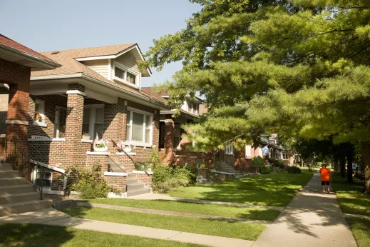 Brick bungalow homes on shaded neighborhood street in North Mayfair