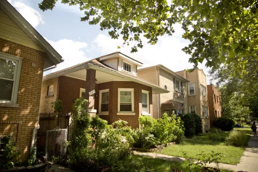 Brick bungalow style house next to apartments in North Park Chicago