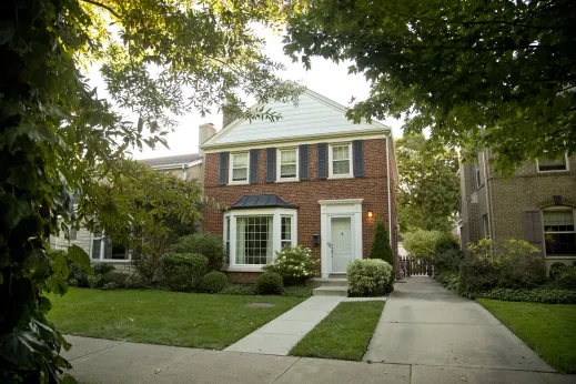 Brick colonial style home and front lawn in Edgebrook Chicago