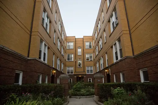 Brick courtyard apartment building and front gate in Graceland West Chicago