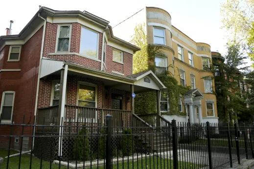 Brick single family home next to six flat apartments in Washington Park Chicago