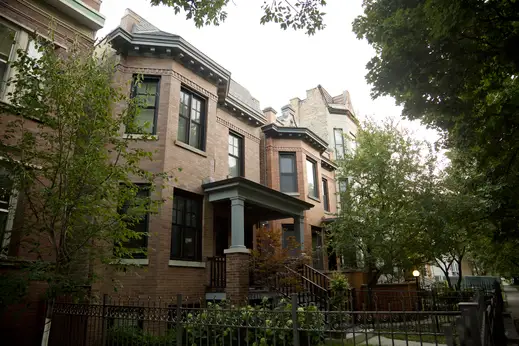 Brick two flat apartment buildings and front yard fences in Graceland West Chicago