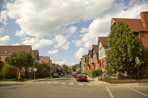 Brightly colored apartments and homes on neighborhood street in Oakland Chicago