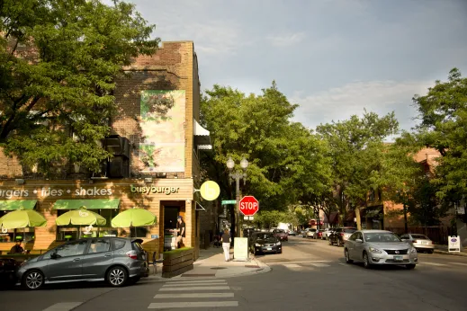 Busy burger restaurant front entrance on S May St in University Village Chicago