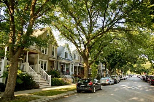 Cars parked on one way street with house and apartments in North Center Chicago