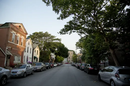 Cars parked on two way street with apartments in Pilsen Chicago