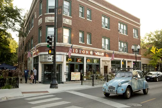 Classic Citroen 2 CV driving on Lincoln Avenue in Lincoln Square Chicago