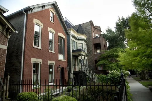 Classic workers cottage style home next to Victorian style house with front gardens in Wicker Park Chicago