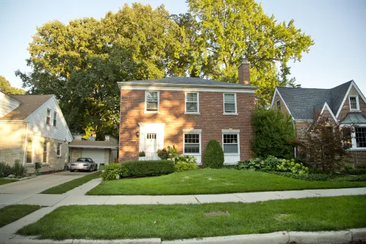 Colonial style brick house and front lawn in Edgebrook Chicago