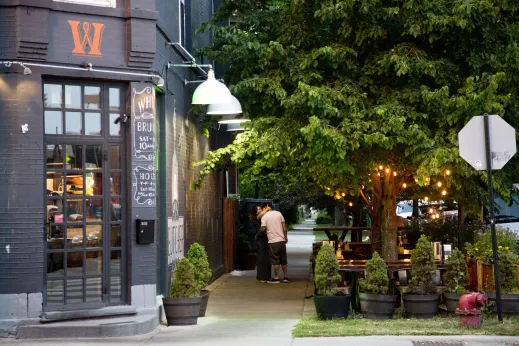 Couple embracing outside Whisk Restaurant in Avondale Chicago