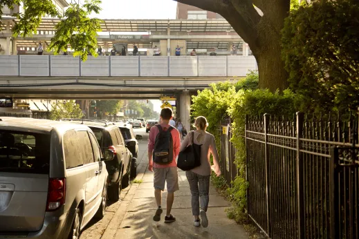 Couple walking on Fullerton elevated train station near DePaul University in Chicago