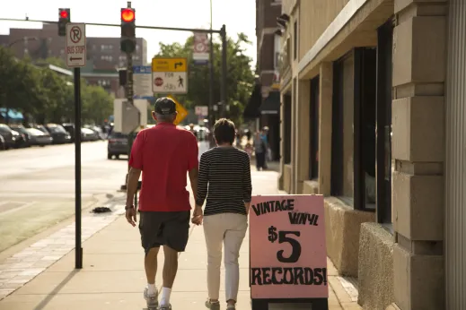 Couple walking by Vintage Vinyl Records on Davis St in Evanston, Illinois